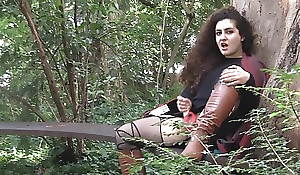 Curly-haired bitch in high boots masturbates into public notice