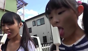 Tiny japanese schoolgirl eating popsicle